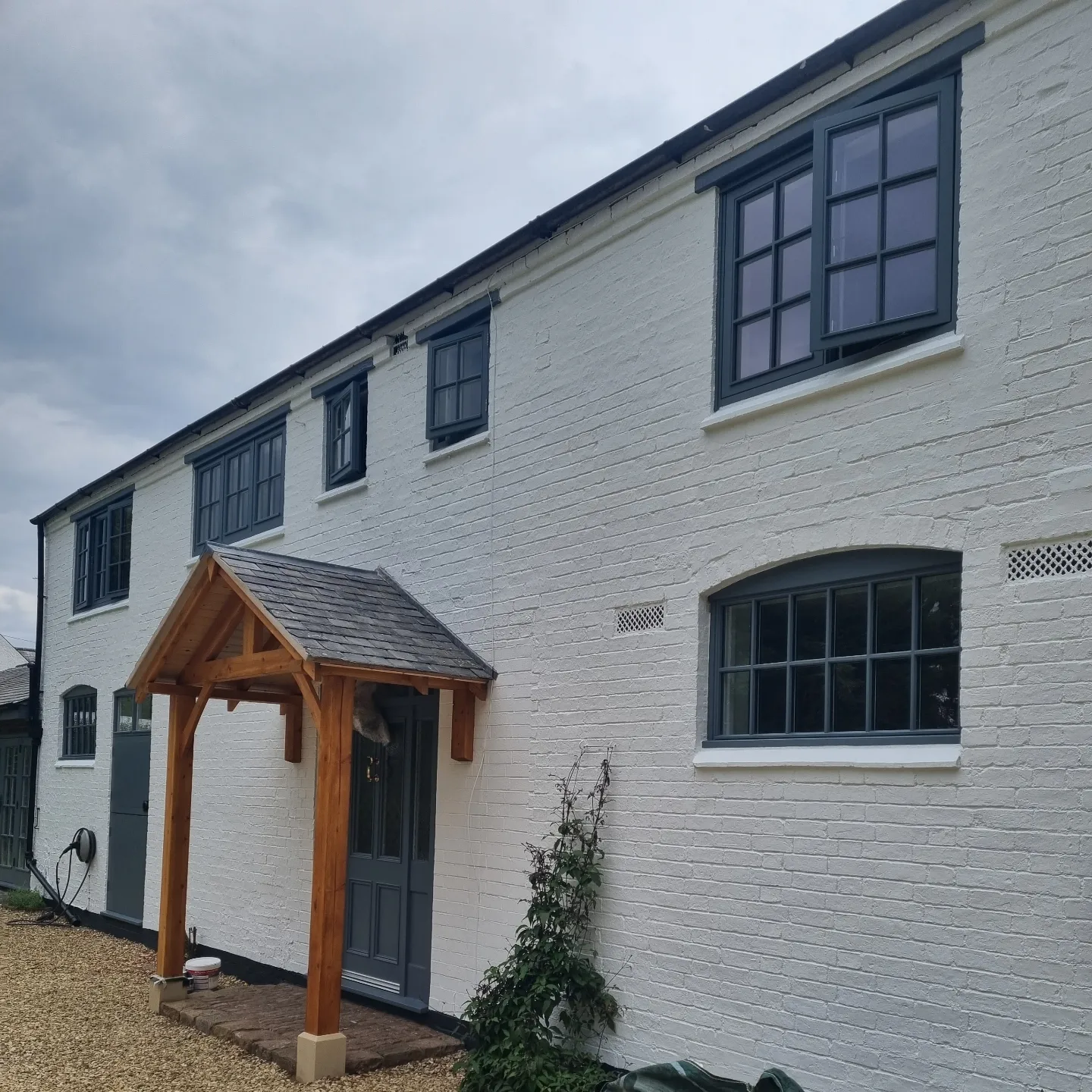 White rendered property with oak porch and freshly repainted windows in Husbands Bosworth, Leicestershire