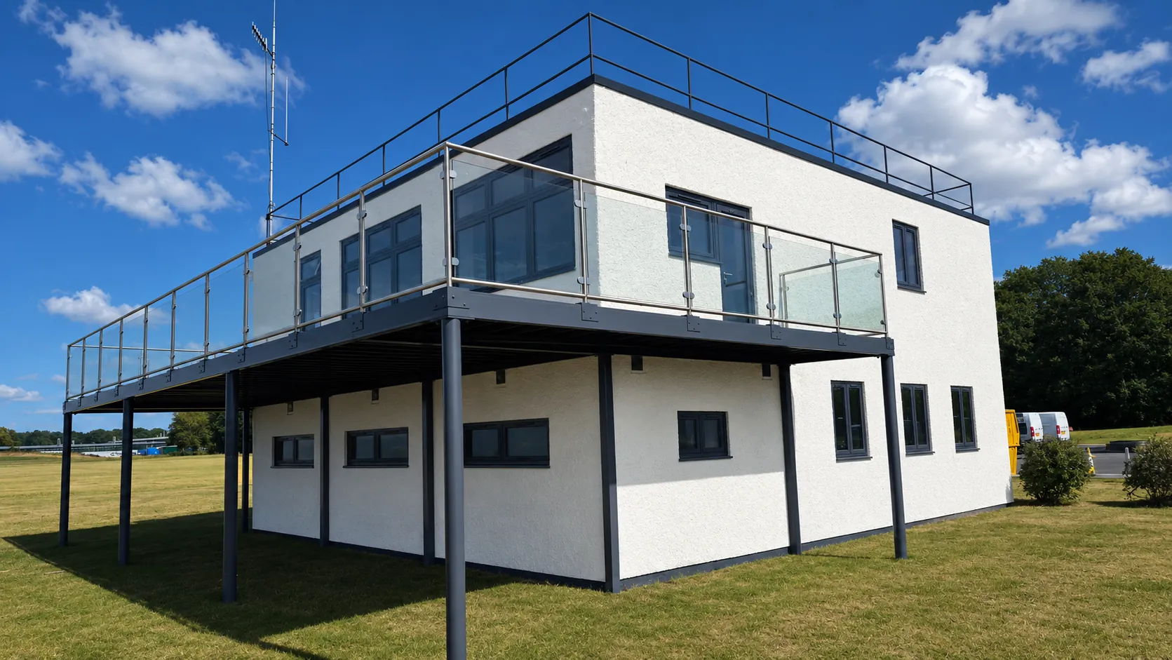 Refurbished two-storey former control tower building with glass balcony at Bruntingthorpe Proving Ground.