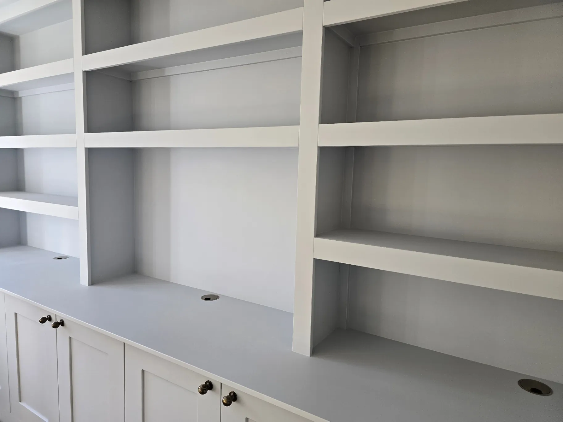 Custom media wall sprayed in an off-white finish