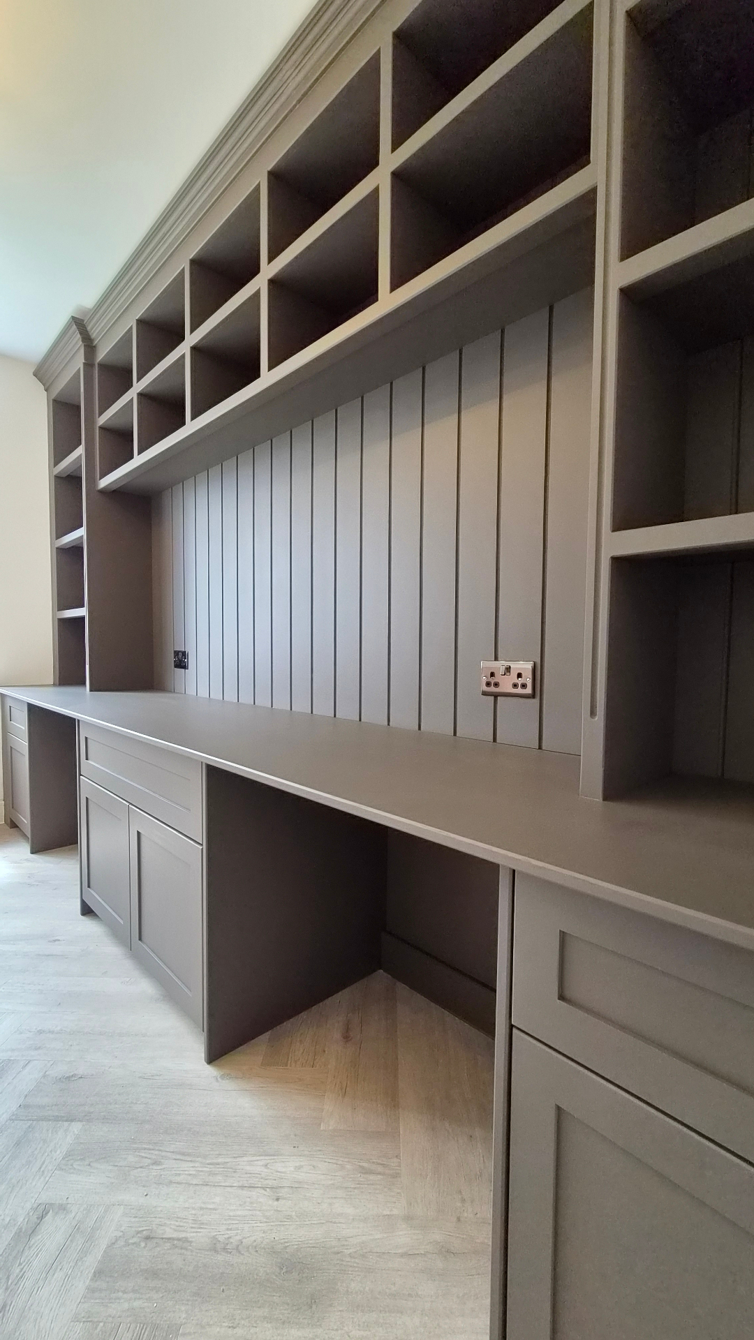 Custom home office cabinetry and fitted shelving professionally spray-painted in a smooth satin grey finish