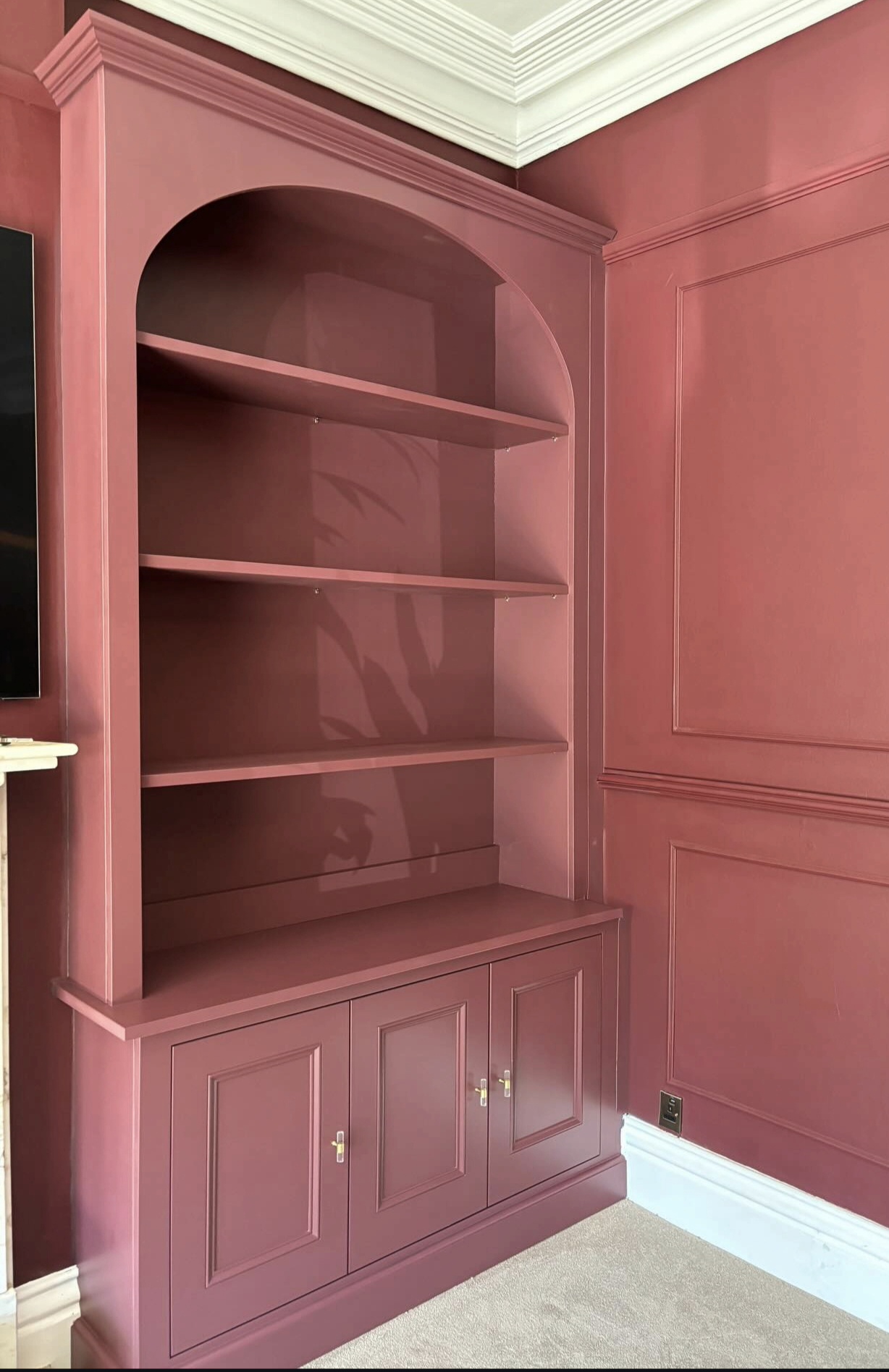 Custom-built alcove shelving unit painted in a vibrant dusty pink satin finish