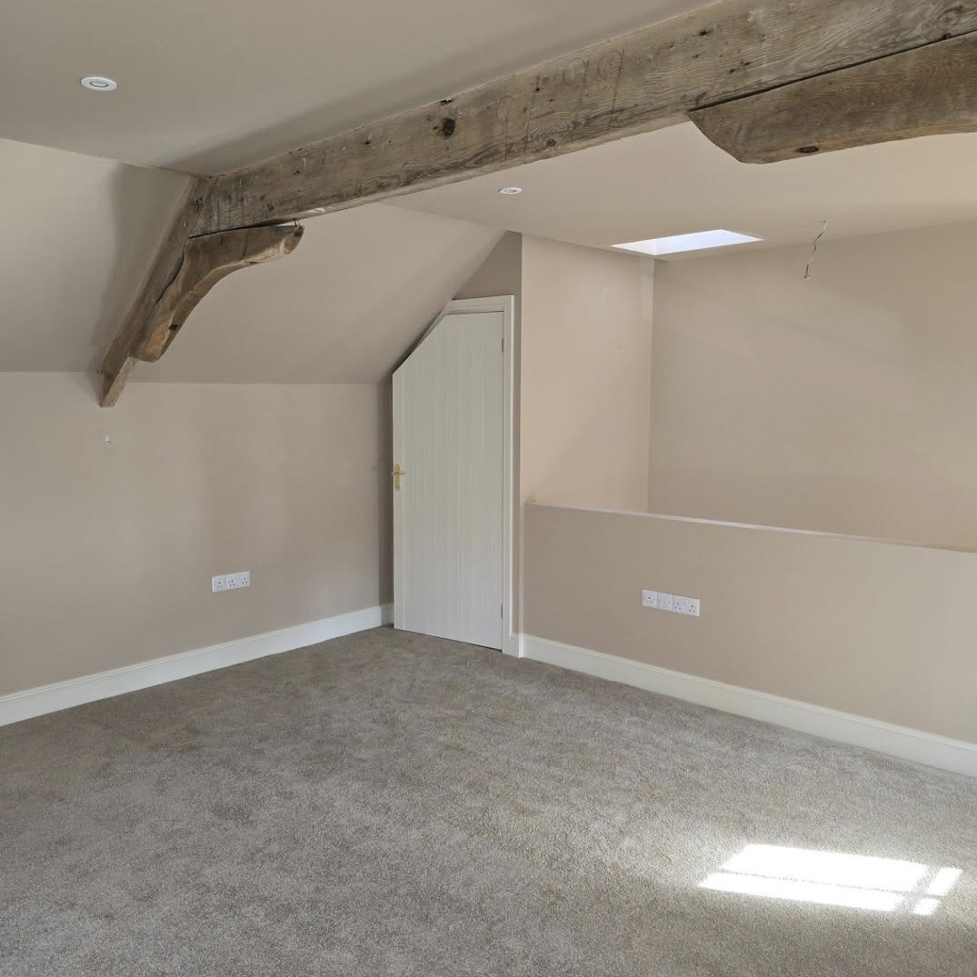Repainted room with exposed roof beam in Harrington, Northamptonshire