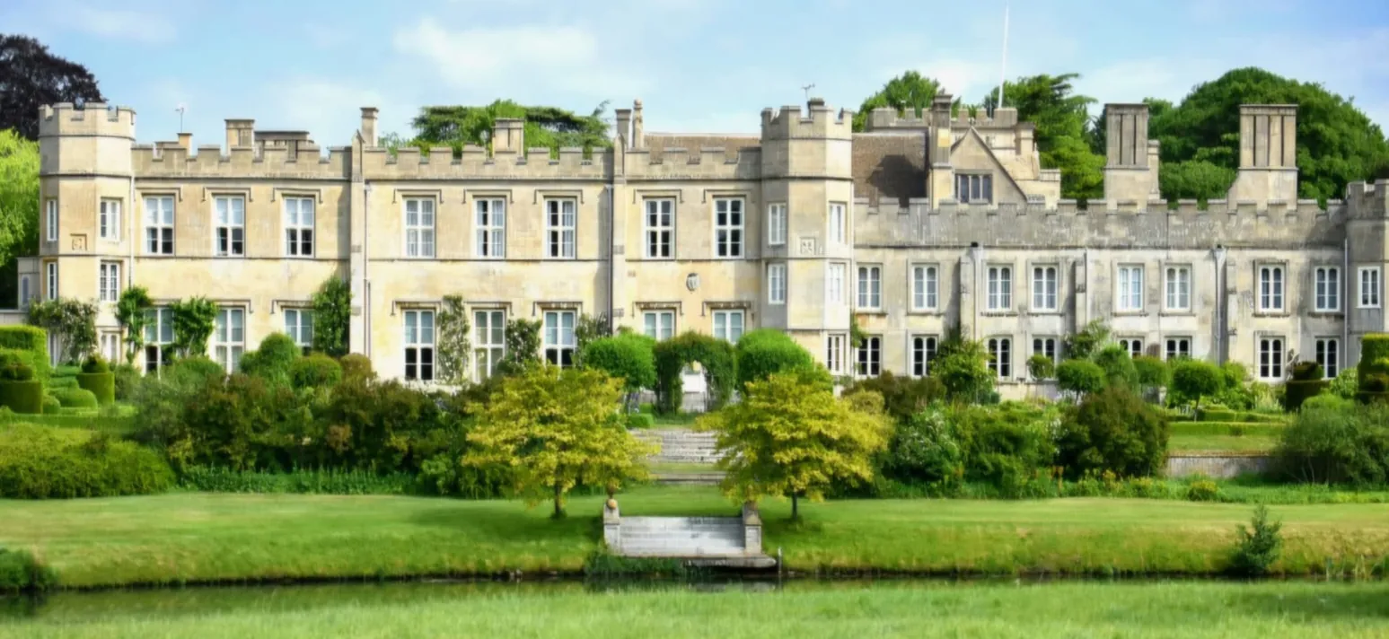 Exterior view of a historic stone country manor house with immaculate exterior paintwork
