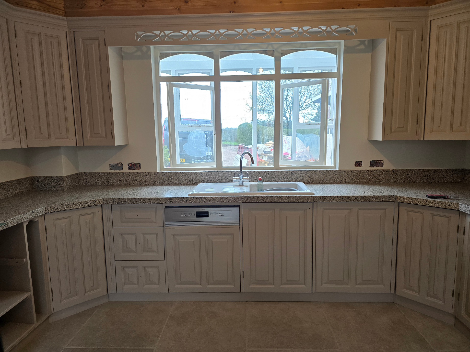After shot of the same kitchen professionally spray-painted in Farrow and Ball Jitney