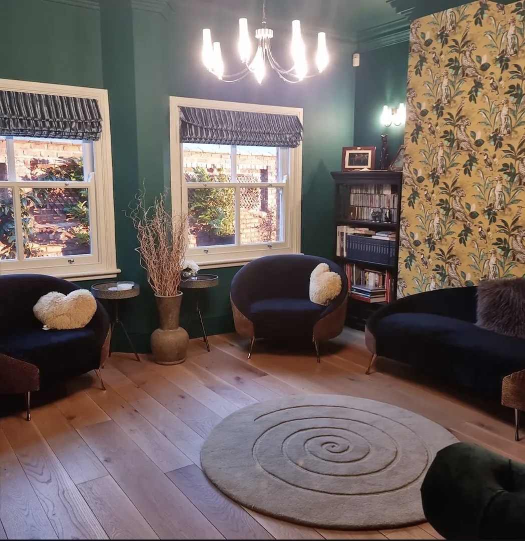 Green sitting room decorated with paint and wallpaper in North Kilworth, Leicestershire