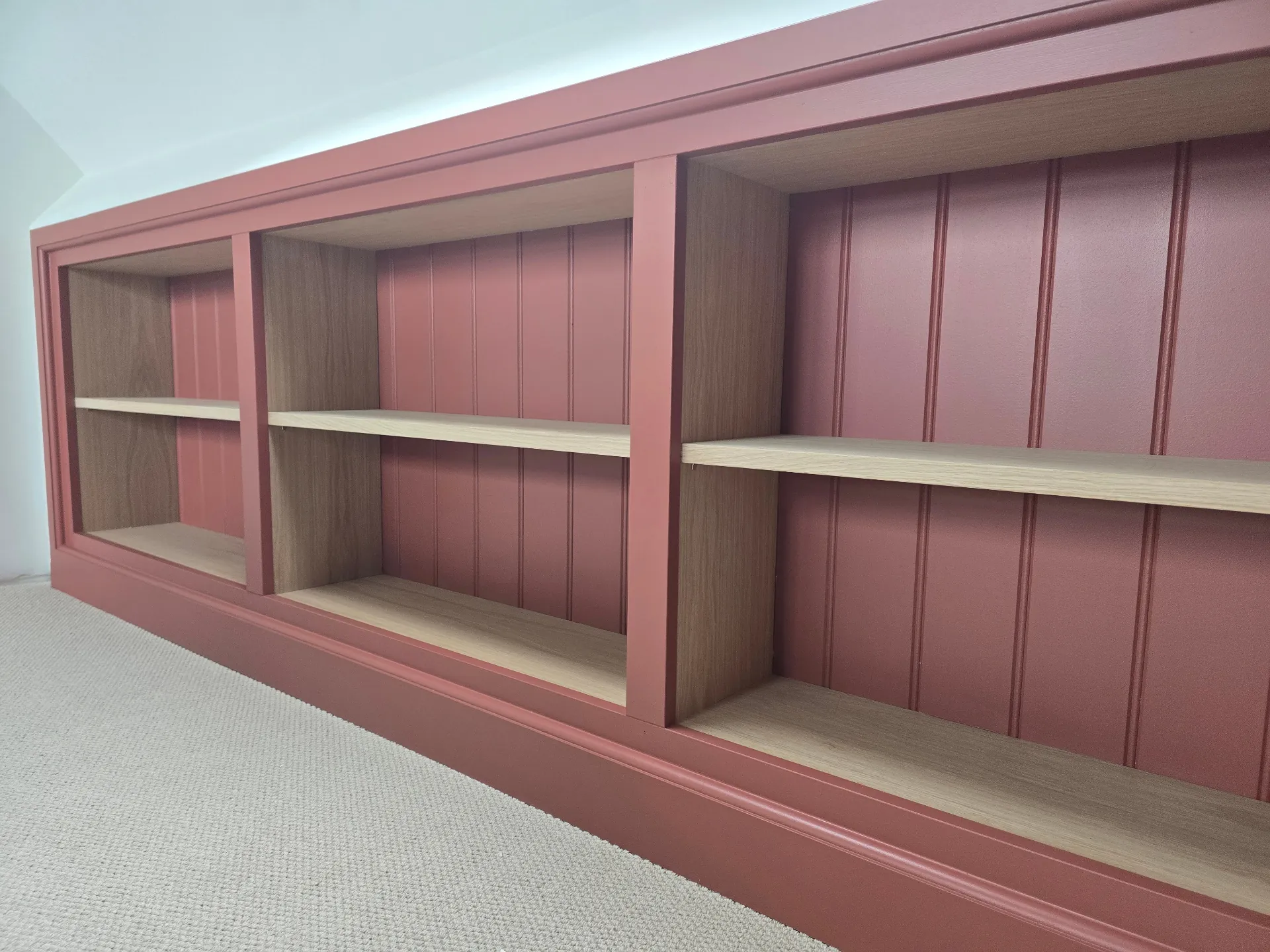 Alcove shelving painted in a deep rusted red satin finish