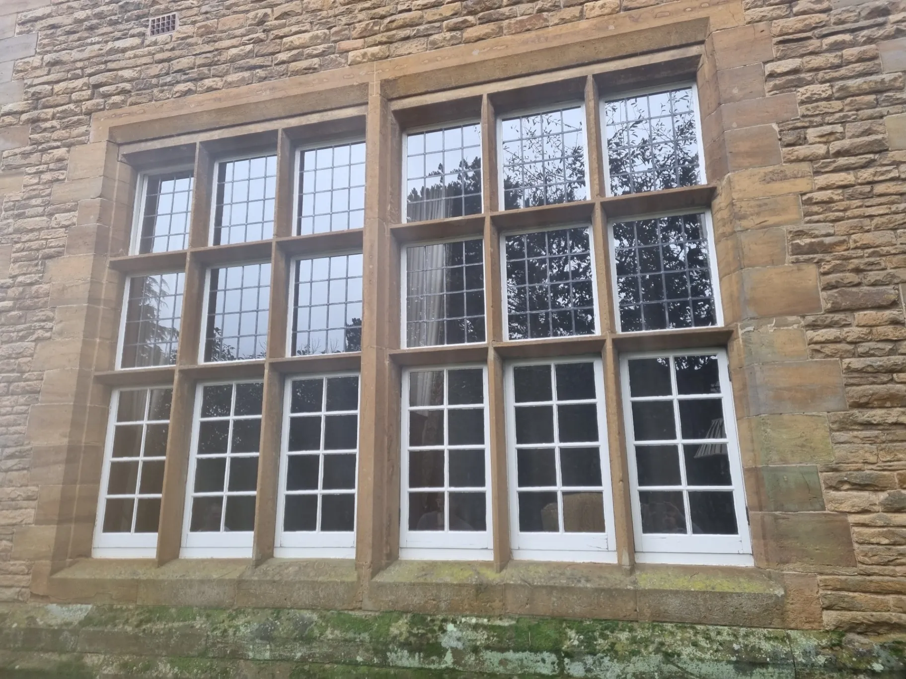 Period wooden windows restored and finished in a high-gloss white in Hinckley