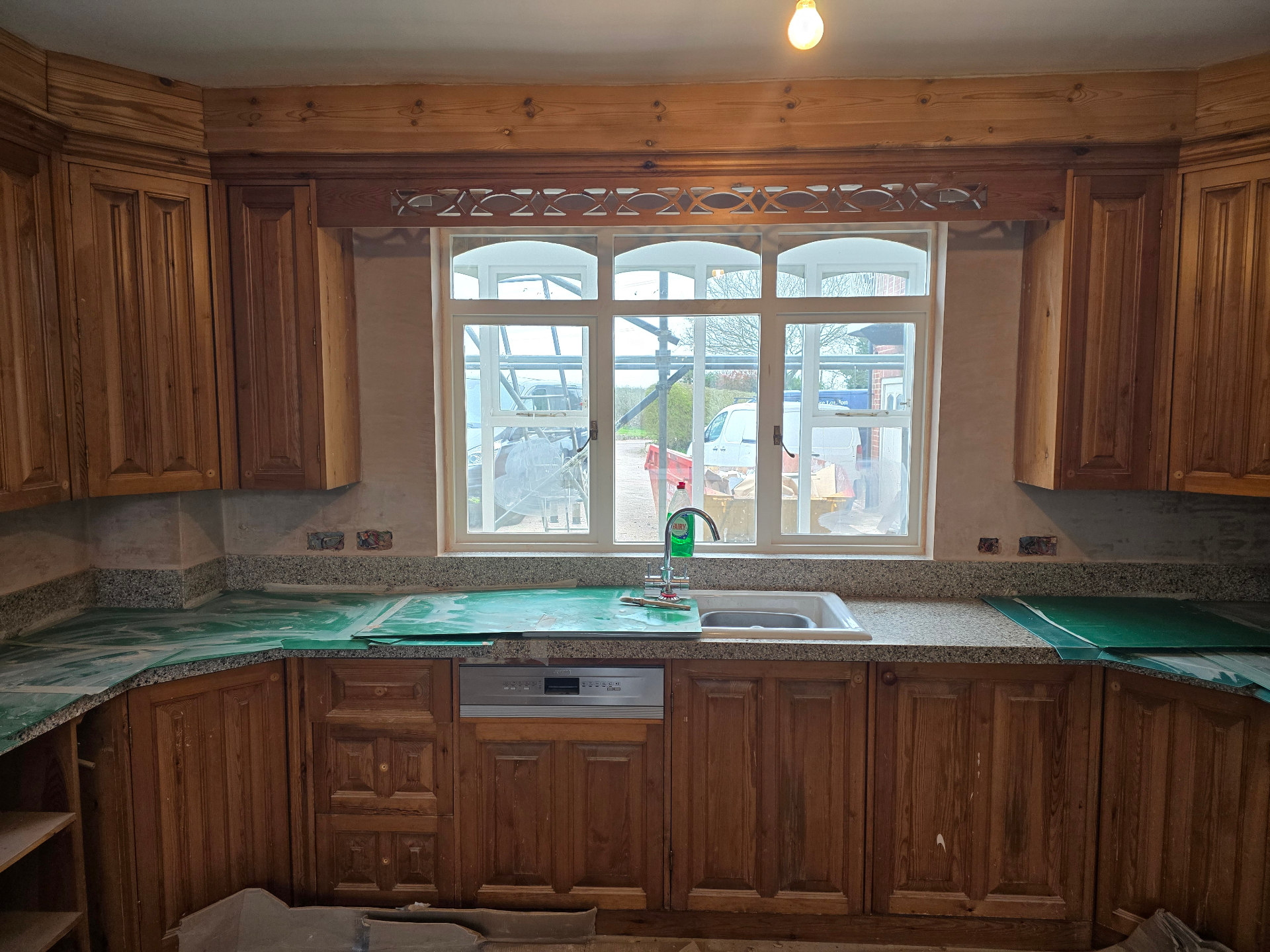Before shot of a residential kitchen with original pine cabinetry prior to painting