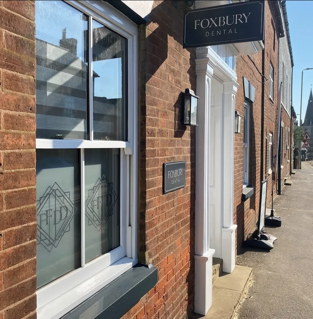 Foxbury Dental brick shopfront with repainted white window and door frames in Husbands Bosworth, Leicestershire